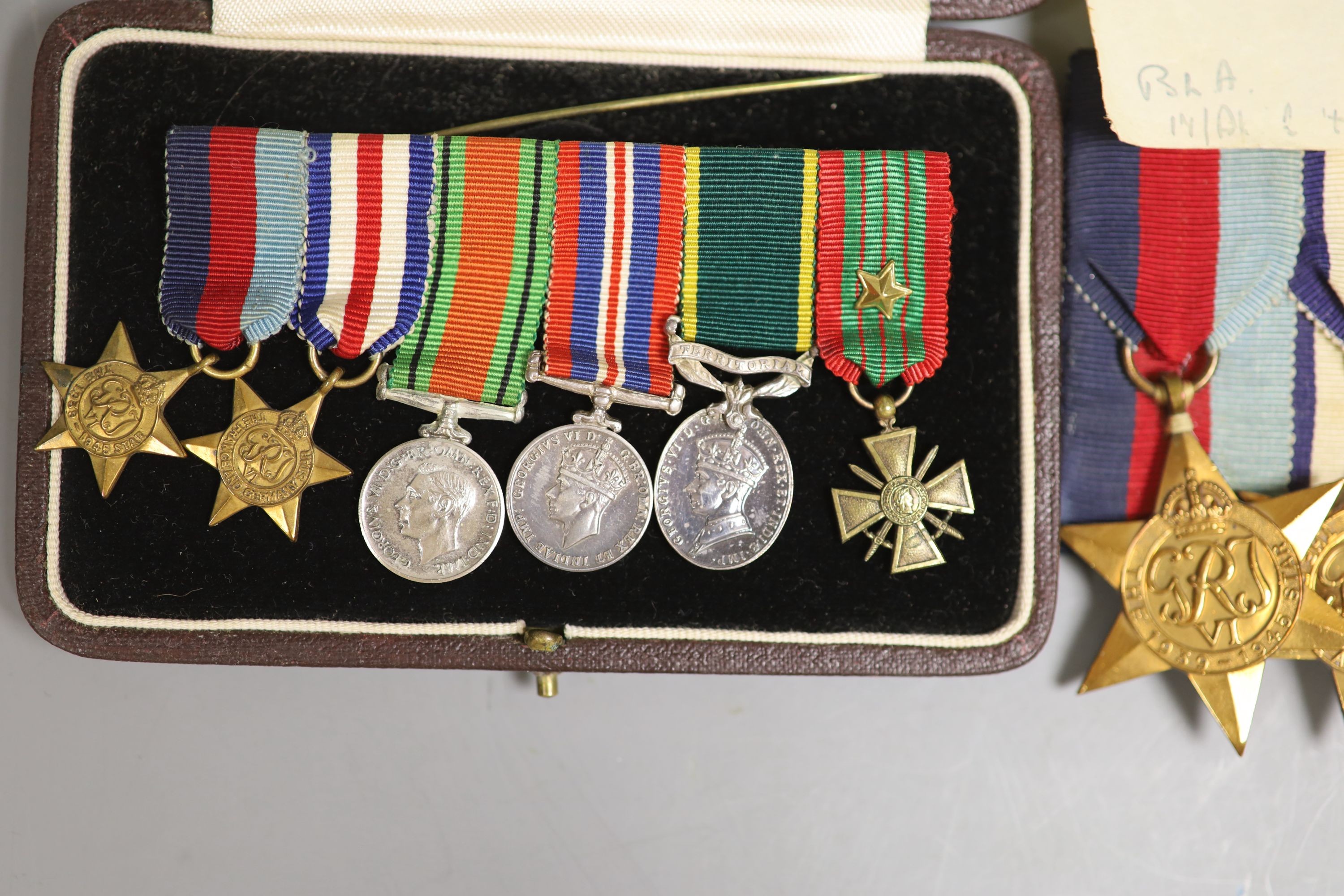 A group of WWII medals and a cased miniature group of medals, probably to War Subs. Maj J K Carson 160470, HQ REME with letter stating that the Croix de Guerre is awarded to officers of 11th Army Division